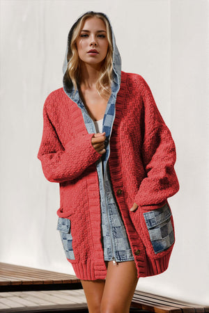 Model wearing a coral hooded denim spliced cardigan with pockets and a cozy knit design.