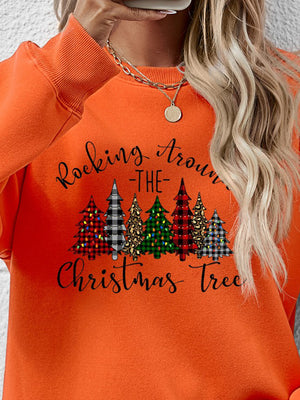 Orange sweatshirt with 'Rocking Around the Christmas Tree' graphic and colorful Christmas trees design.