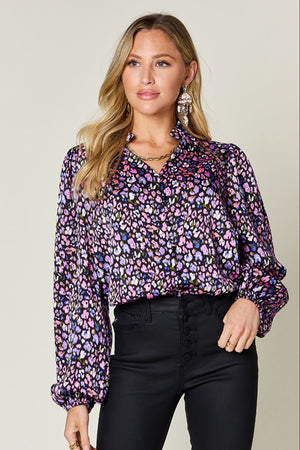 Double Take long sleeve blouse in colorful printed pattern, styled with black pants for a chic look.