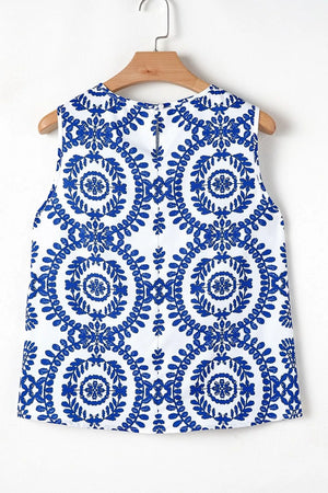 Printed crew neck sleeveless top with blue floral pattern on white background, perfect for casual summer wear.