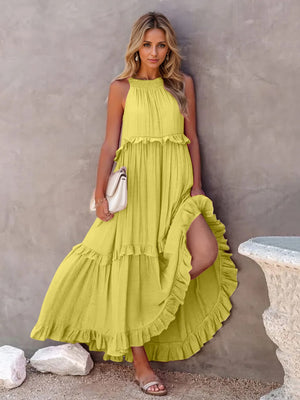 Ruffled sleeveless tiered maxi dress in vibrant yellow, featuring pockets and a flowing high-low hem.