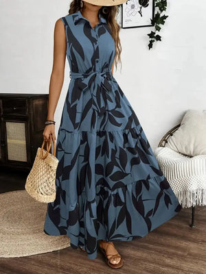 Stylish printed tie waist sleeveless maxi dress in blue with floral pattern, perfect for summer outings.