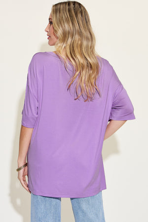 Model showcasing the Basic Bae Full Size Bamboo V-Neck Drop Shoulder T-Shirt in purple from the back.