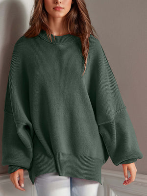 Chic side-slit sweater in cozy green with round neck, providing comfort and style for winter wardrobes.