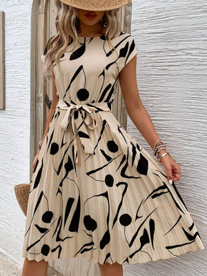 Tied pleated printed cap sleeve dress in beige with black abstract patterns, perfect for summer outings.