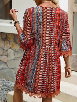 Vibrant lace trim printed V-neck dress with 3/4 sleeves, showcasing a colorful pattern and stylish back view.