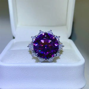 10 Carat Moissanite flower ring in 925 sterling silver, featuring a stunning purple center stone, displayed in a jewelry box.