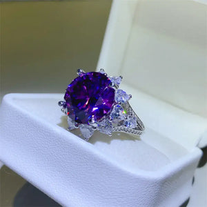 Stunning purple gemstone ring with sparkling accents, displayed in elegant jewelry box.
