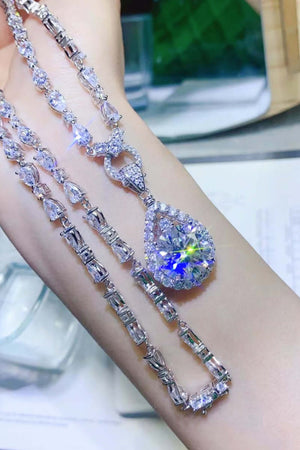 Stunning 10 carat Moissanite teardrop pendant necklace on a model's wrist, featuring sparkling zircon accents.