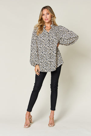 Stylish woman wearing a leopard print long sleeve blouse, paired with black pants and heels, perfect for chic casual outings.