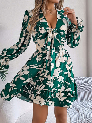 Green floral ruffled long sleeve dress with a tied neckline, perfect for stylish summer outings.