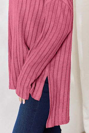 Side view of a pink ribbed high-low long sleeve t-shirt featuring a slit detail, perfect for casual wear.