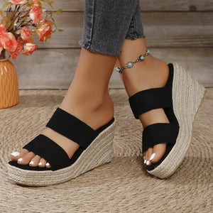 Open toe platform wedge sandals with black straps and woven sole, perfect for stylish summer outfits.