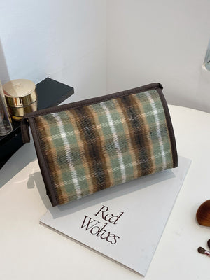 Small contrast plaid clutch bag with zipper, featuring green and brown pattern, ideal for stylish storage.
