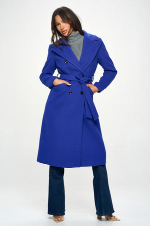 Stylish blue double-breasted longline coat with belt, perfect for layering and providing warmth. Elegant outerwear option.