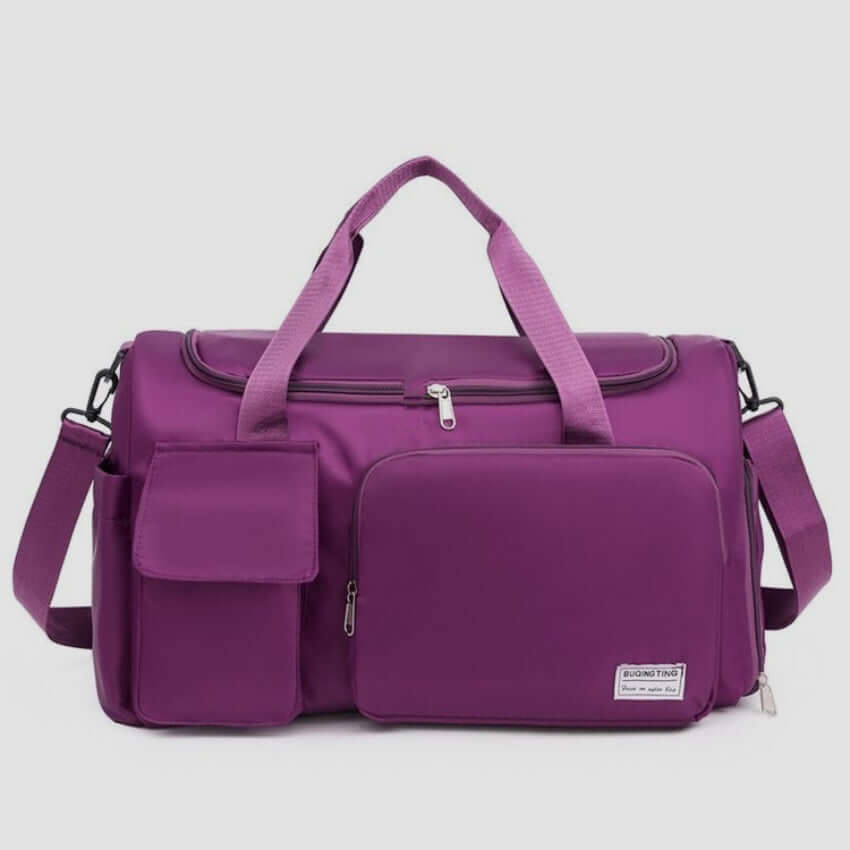 Oversize purple Oxford cloth travel bag with detachable strap and multiple pockets for organized packing.