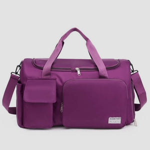 Oversize purple Oxford cloth travel bag with detachable strap and multiple pockets for organized packing.