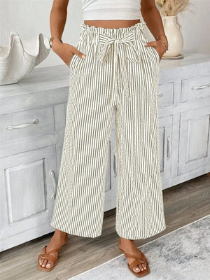 Full size striped wide leg paper bag pants in cream with pockets, featuring a tied waist, shown on a model.