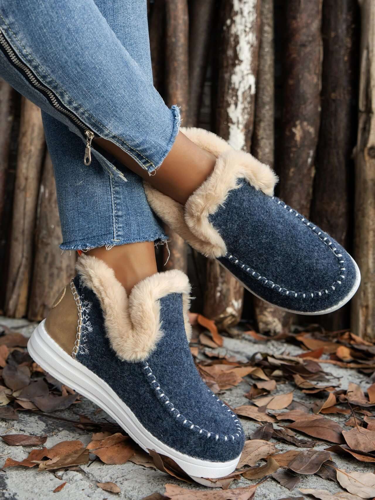 Furry suede round toe flat sneakers in navy, featuring plush lining and rubber soles, paired with distressed jeans.