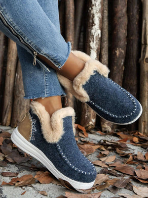 Furry suede round toe flat sneakers in navy, featuring plush lining and rubber soles, paired with distressed jeans.