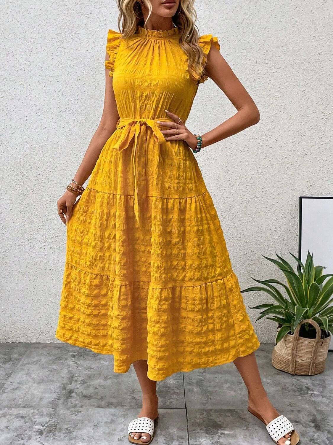 Tied ruffled cap sleeve midi dress in vibrant yellow, featuring a belted waist and a flowy, tiered design.