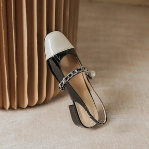 Contrast round toe block heel Mary Jane shoes in black and white with chain detail, perfect for stylish comfort.