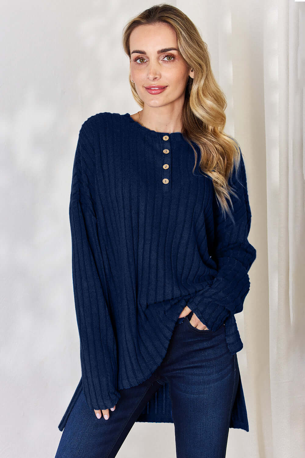 Model showcasing a navy ribbed high-low long sleeve t-shirt with button detail and relaxed fit.
