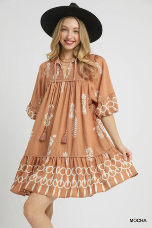 Umgee Boarder Print Mini Dress with tassel tie neck, vibrant mocha color, perfect for summer outings.