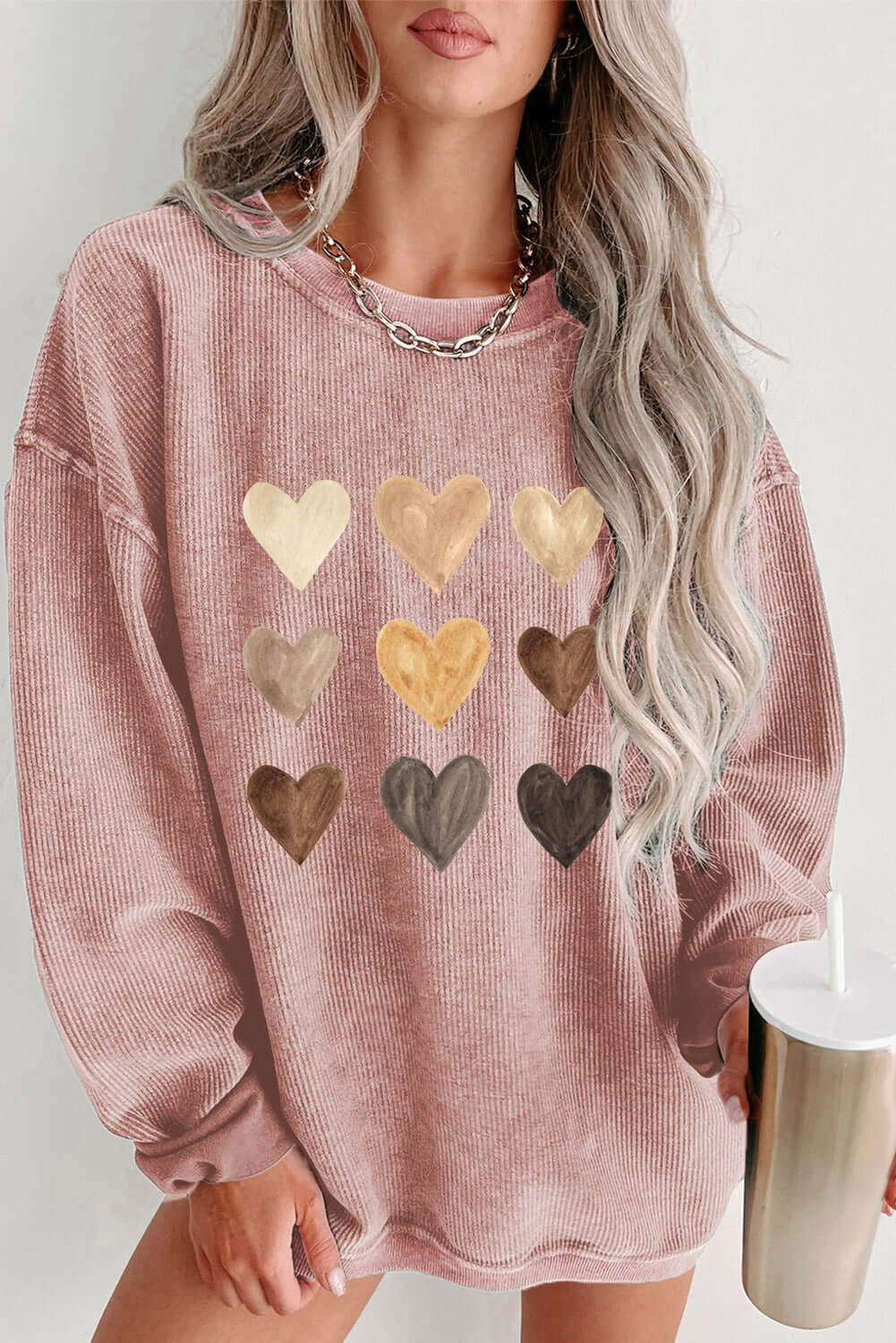 Heart round neck dropped shoulder sweatshirt in pink with various heart designs, perfect for casual style.