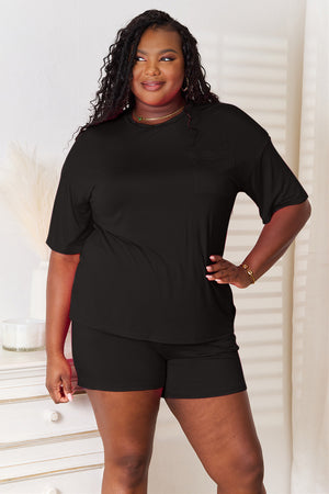 Model wearing a black soft rayon half sleeve top and shorts set, showcasing a stylish and relaxed look.