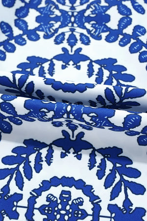 Close-up of vibrant blue floral print fabric on a white background, ideal for stylish printed crew neck sleeveless tops.