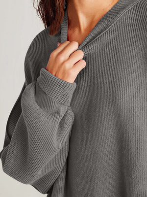 Cozy gray side-slit sweater highlighting soft fabric and stylish round neck detail.