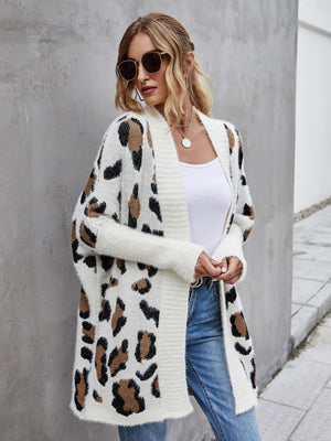 Stylish woman in leopard pattern fuzzy cardigan, showcasing casual fashion with open front and long sleeves.