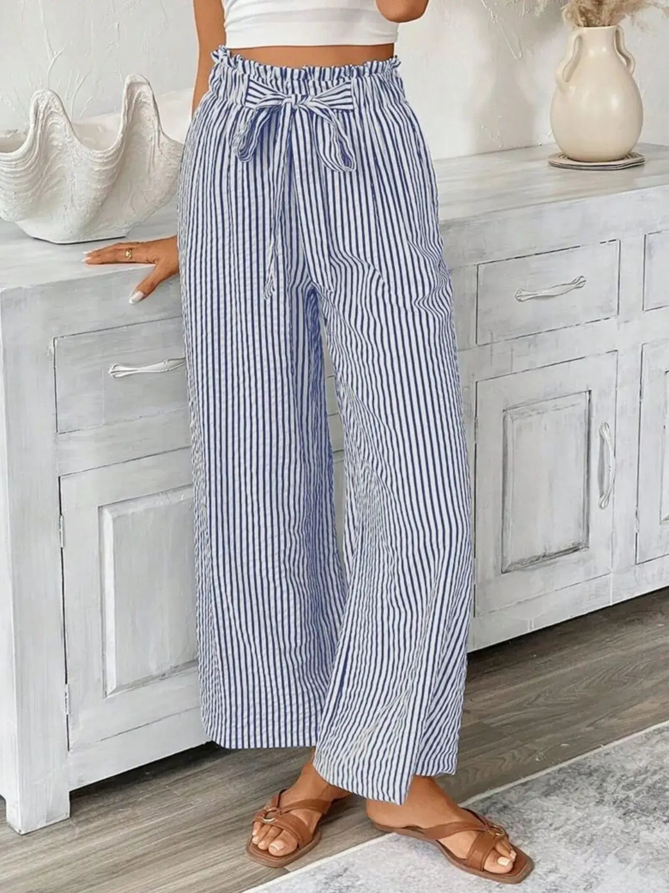Full size striped wide leg paper bag pants with pockets and tie detail, styled with sandals.