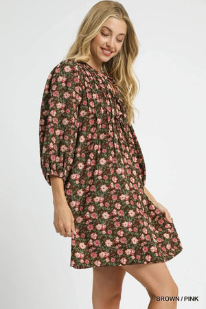 Umgee floral tie-neck babydoll dress in brown and pink, showcasing a charming and feminine silhouette.
