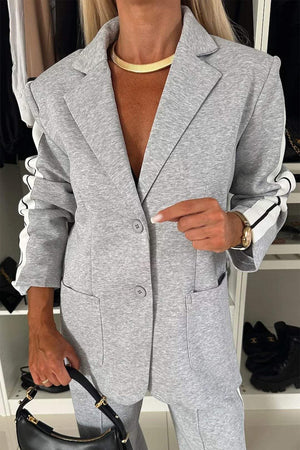 Model wearing a stylish gray lapel collar top with a buttoned front and pockets, perfect for a chic two-piece set.
