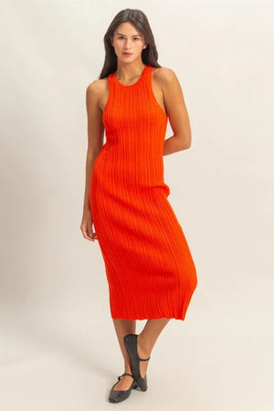 Model wearing an orange ribbed knit bodycon dress with round neck and mid-length silhouette.