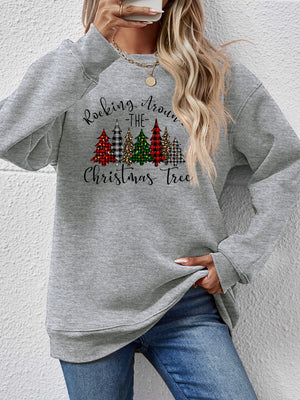 Gray sweatshirt featuring a festive graphic of Christmas trees and the phrase "Rocking Around the Christmas Tree".