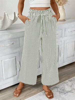 Full size striped wide leg paper bag pants in plus size, featuring pockets and tied waistband, styled with a crop top.