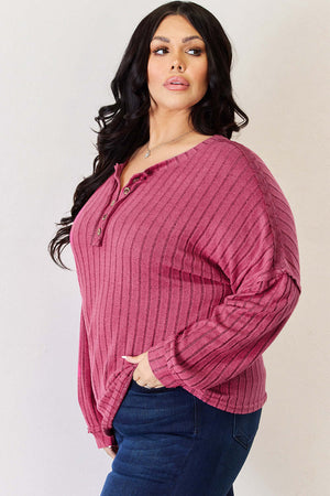 Curvy model wearing Basic Bae ribbed half button long sleeve high-low t-shirt in mauve, styled with jeans.