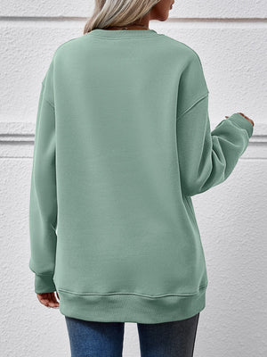 Back view of a soft green sweatshirt, showcasing its relaxed fit and cozy style.