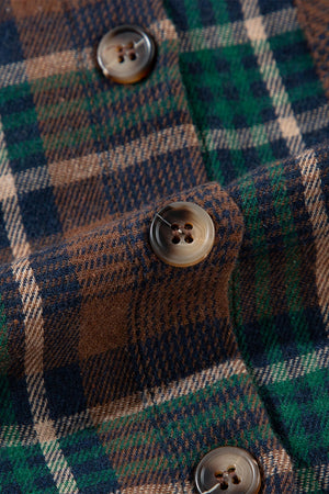 Close-up of a plaid fabric with buttons, showcasing rich colors of green, brown, and navy.