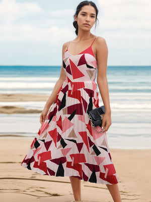 Pleated geometric spaghetti strap dress in vibrant colors, perfect for summer outings at the beach.