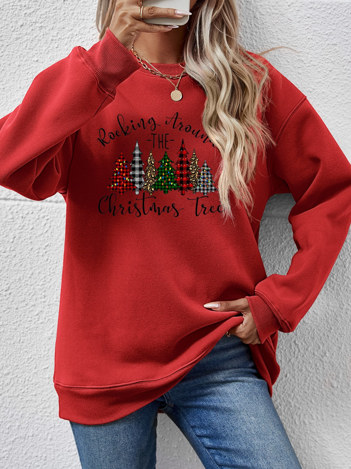 Red sweatshirt featuring Christmas tree graphic, perfect for festive holiday gatherings.