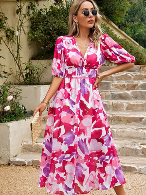 Stylish Printed Puff Sleeve Midi Dress in vibrant pink and purple floral pattern, perfect for casual outings or special occasions.