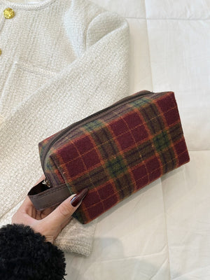 Small contrast plaid clutch with zipper, featuring rich burgundy, green, and brown tones, perfect for stylish storage.