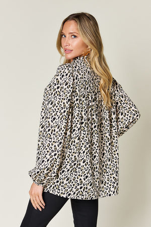 Model showcasing a double take full size leopard long sleeve blouse, featuring a stylish frill and spacious fit.