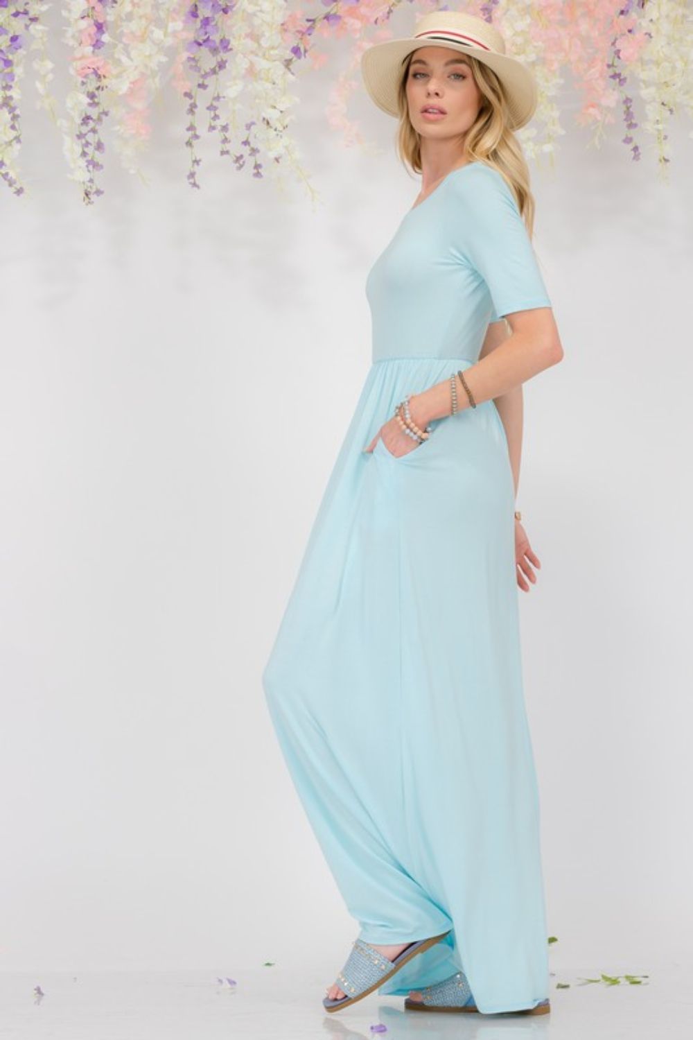Celeste Plus Size Maxi Dress in light blue, featuring short sleeves, round neck, and pockets for added convenience.