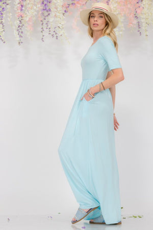 Celeste Plus Size Maxi Dress in light blue, featuring short sleeves, round neck, and pockets for added convenience.