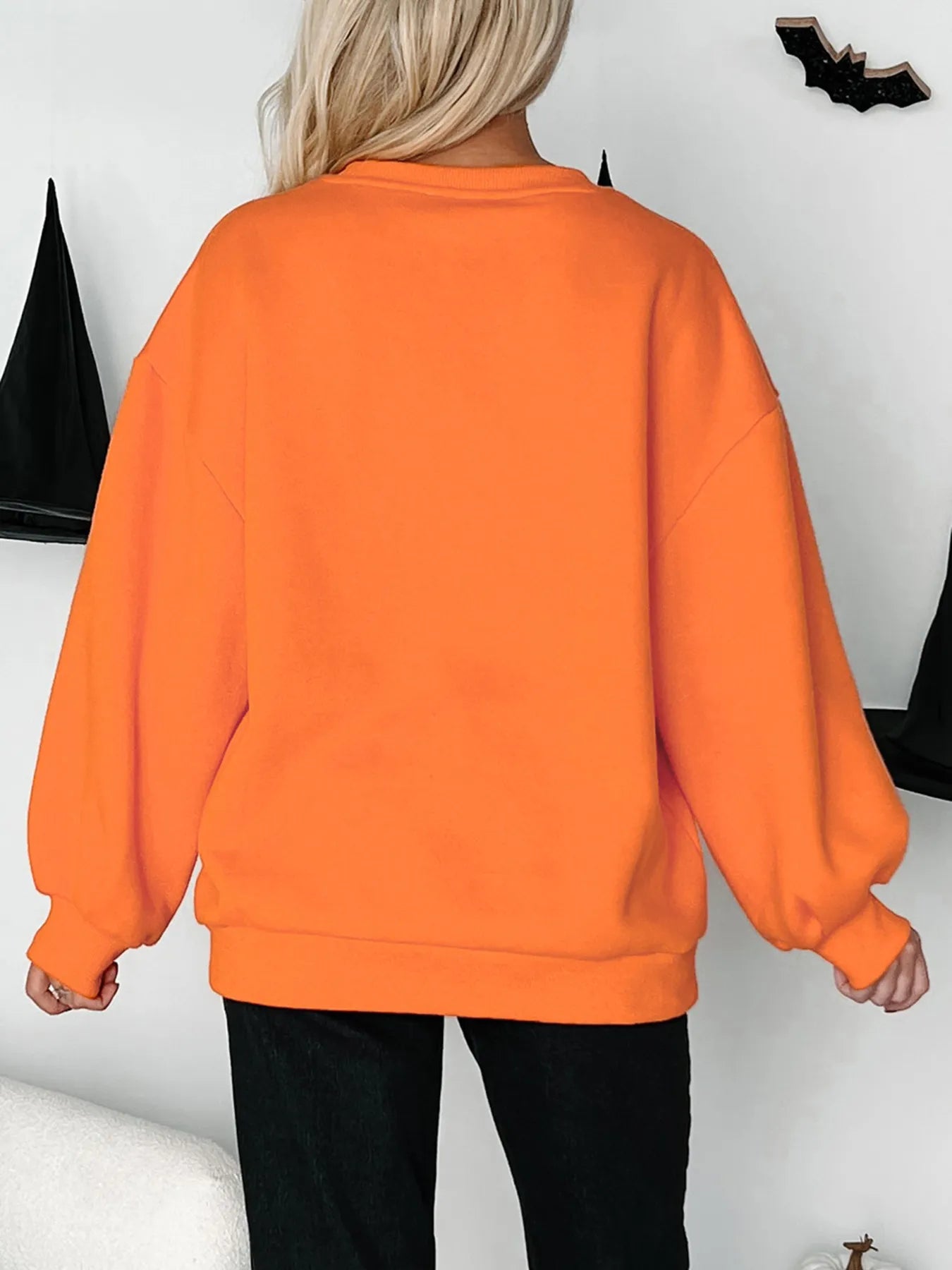 Back view of an orange Halloween Skeleton Pumpkin sweatshirt with a relaxed fit and cozy sleeves.